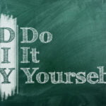 The phrase "Do It Yourself" is written in a chalk-like font on a green chalkboard. The acronym "DIY" is vertically aligned on the left side, with each letter stacked on top of each other. The words "Do It Yourself" are aligned horizontally on the right. The design creates a sense of creativity and self-sufficiency, commonly associated with DIY projects.