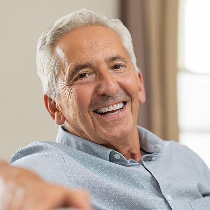 Smiling Woman Smiling elderly man in a blue shirt